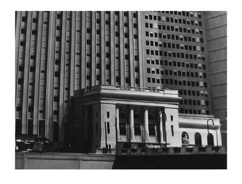 Photograph of a street corner, in which multiple buildings are the only thing visible.