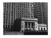 Photograph of a street corner, in which multiple buildings are the only thing visible.