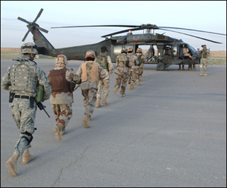 Iraqi soldiers board a Black Hawk helicopter.