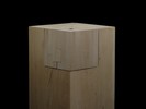 Photograph of bass wood cube model on basewith shifted portions of the cube.