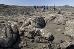 Students hiking across a barren landscape.