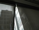 Photo of a building seen through a window.