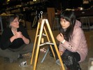 Photo of students observing a simple pendulum made of a block of wood and a string.