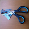 Photograph of scissors cutting a credit card.