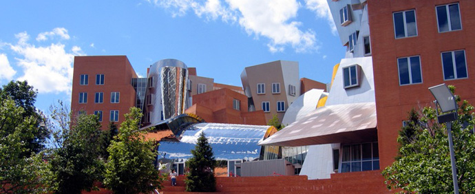 A photograph of the exterior of a building on the MIT campus on a sunny day.