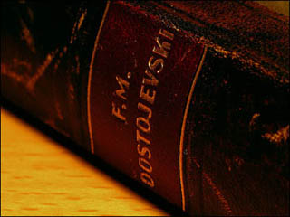 Close-up of the the spine of a book bound in deep brown leather.