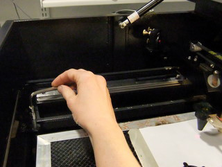 Photo of hand adjusting the height of the table.