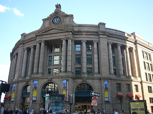 The exterior façade of a large building, with tall granite columns.