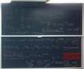 Radioactivity related equations on two blackboards.