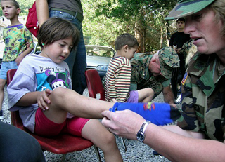 A photograph of a young girl recieving a new pair of shoes and socks.