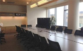 View of conference table and chairs toward the back of the room.