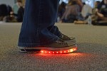 Sneakers with a strip of red lit up LEDs.